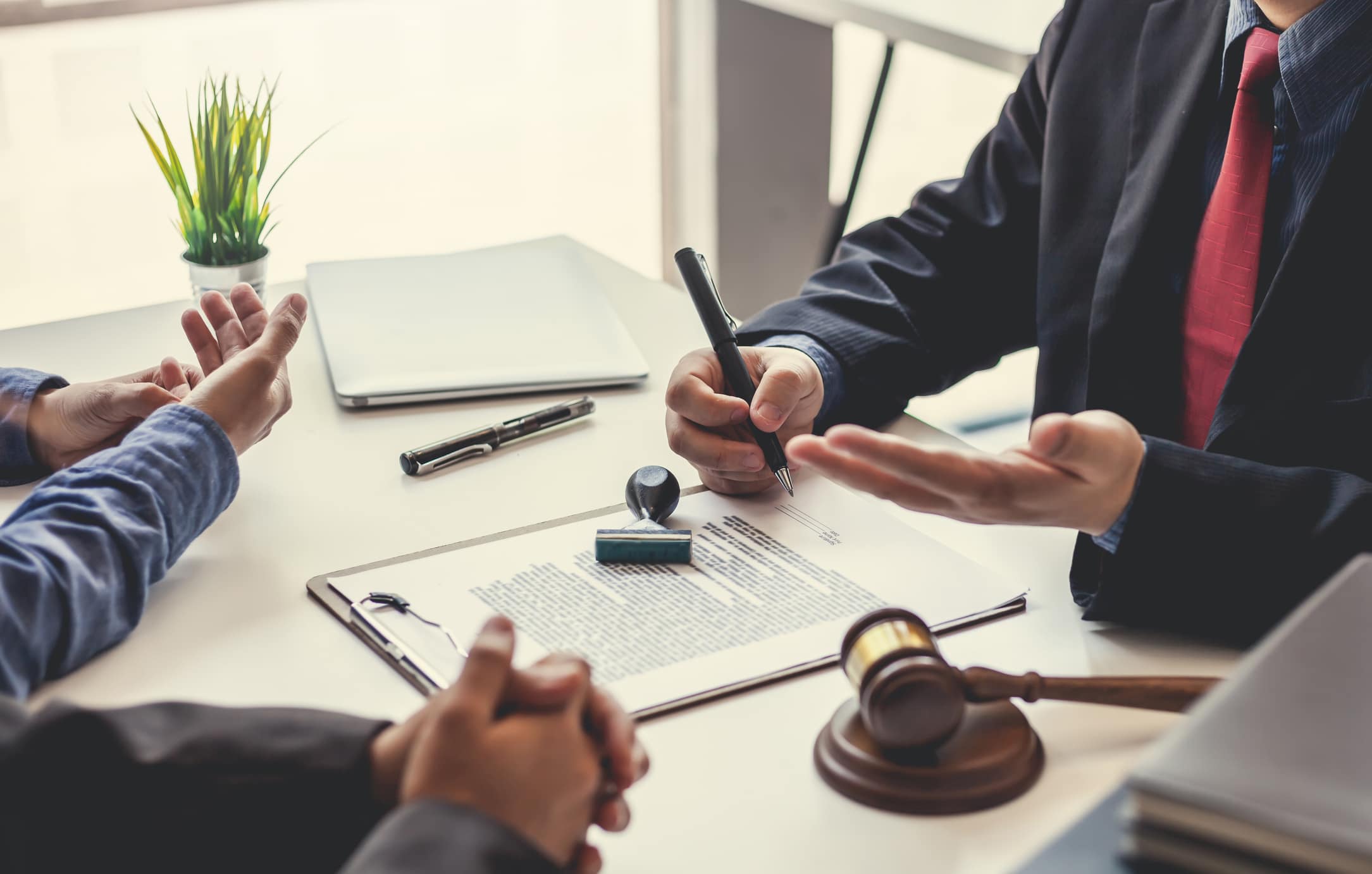 Business people and lawyers talk and contract together. Signing of a contract in the presence of an attorney.